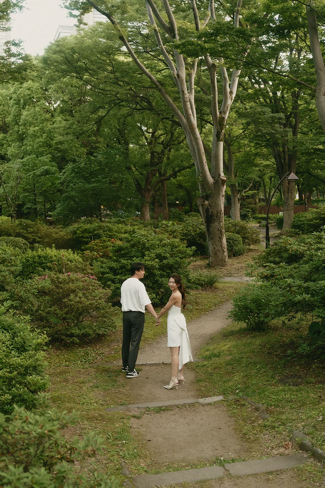 Looking back on a garden path, hand in hand